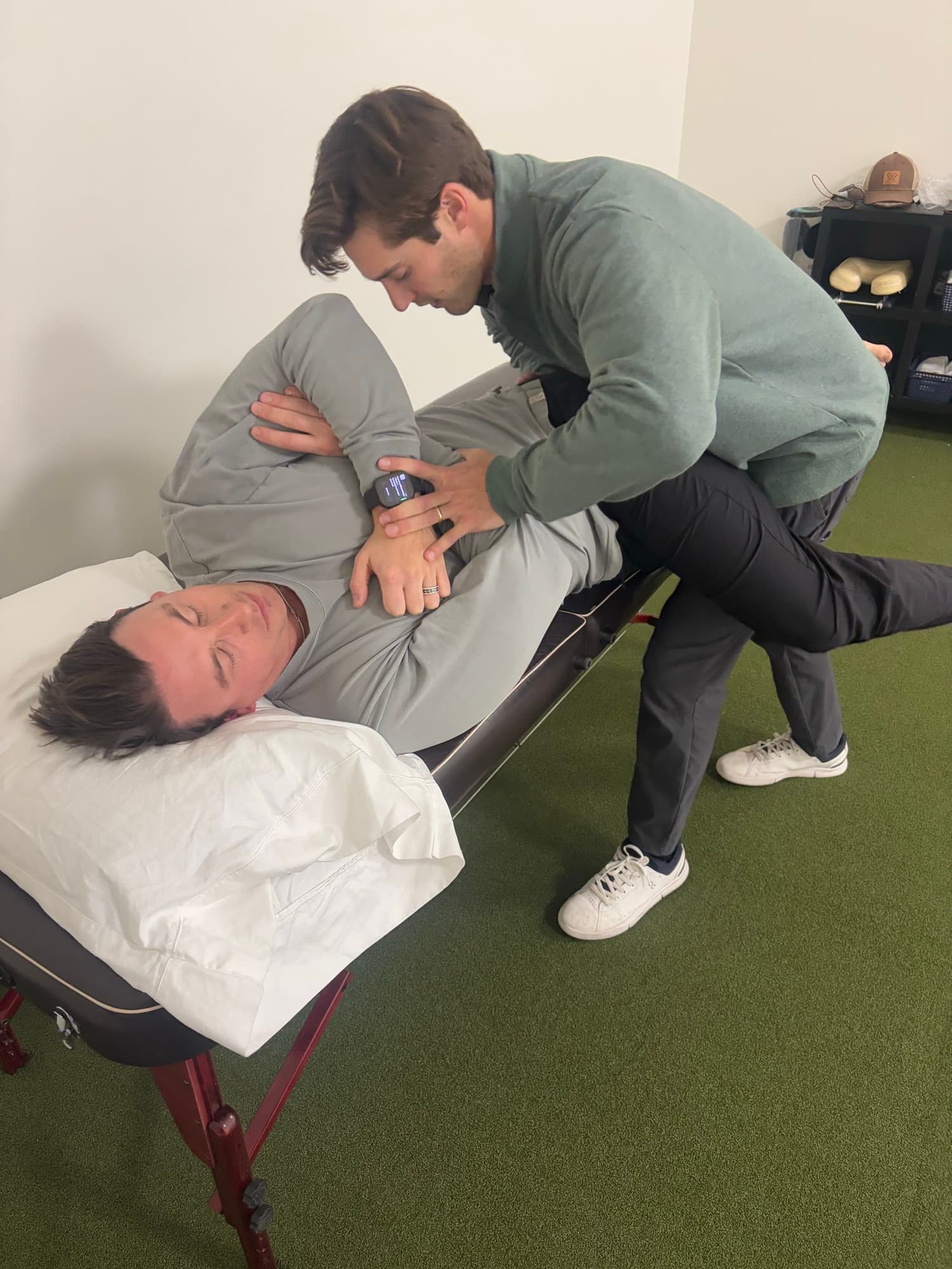Dr. Taylor Wolf performing a side-lying chiropractic adjustment on a patient in Salt Lake City.