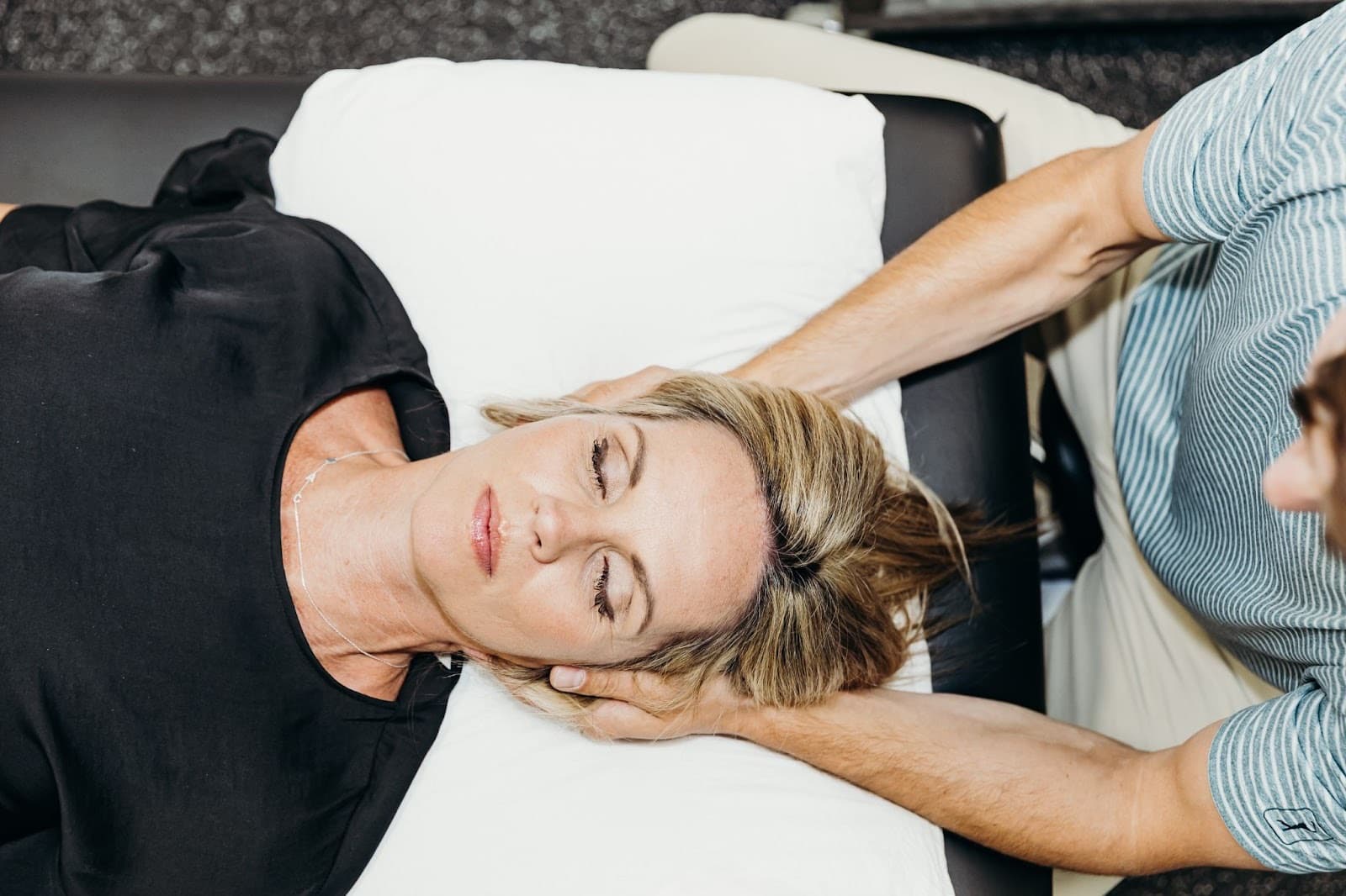 Overhead view of gentle cervical spine treatment for headache relief at Elevated Sport and Spine.