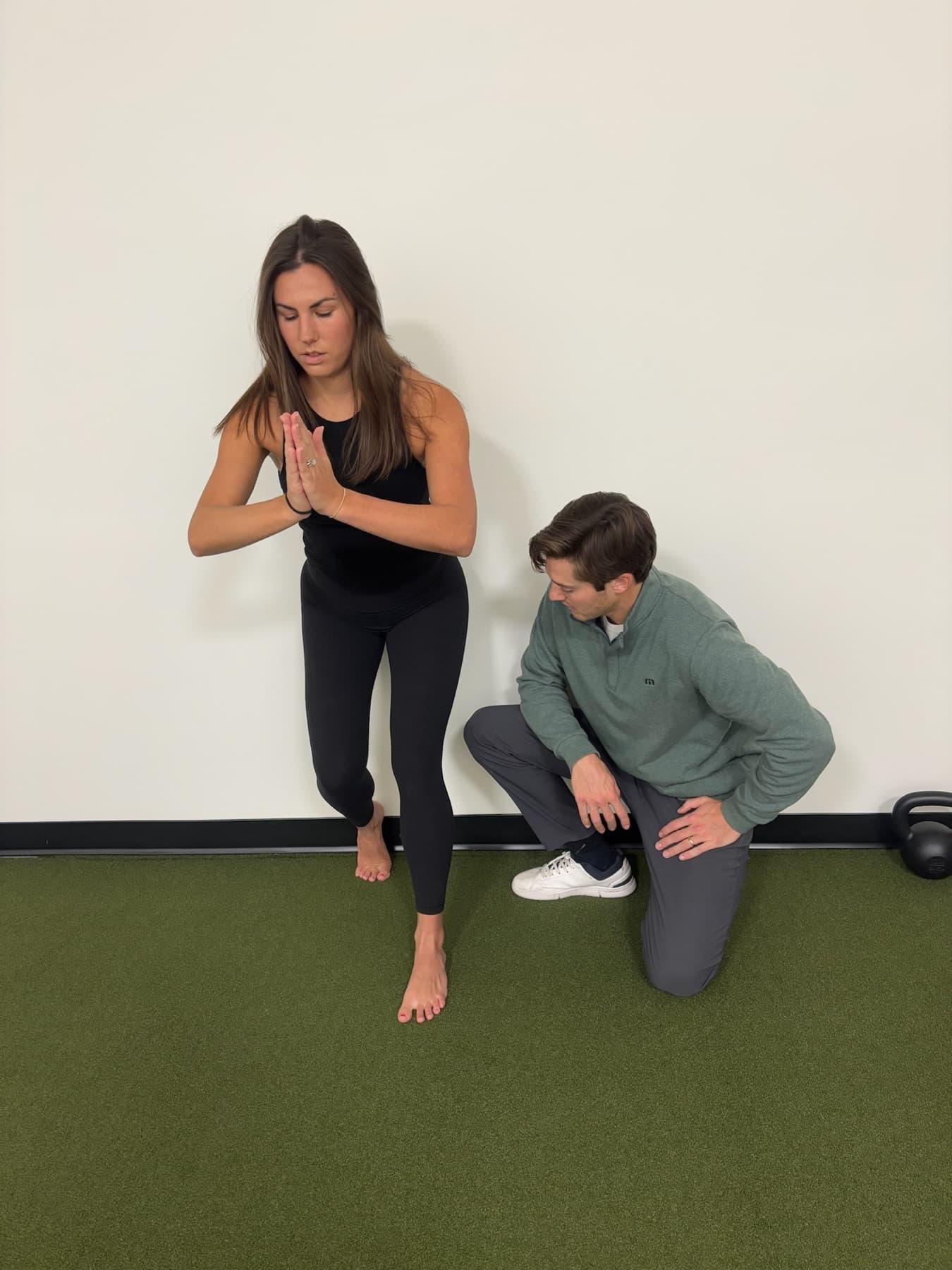 Dr. Taylor Wolf assessing a patient's lunge pattern during a specialized movement evaluation.