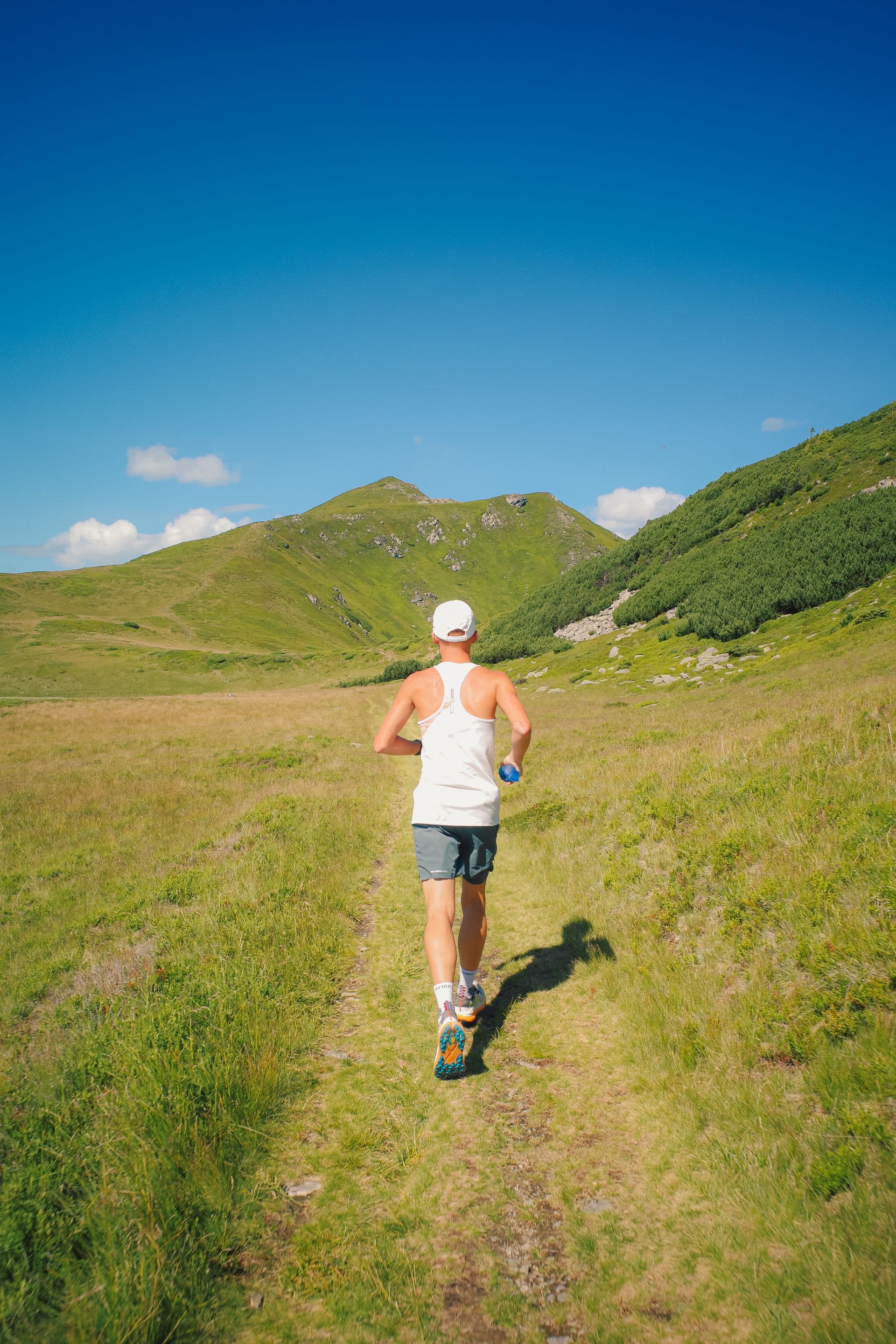 Runner on a scenic mountain trail, the kind of terrain Salt Lake City runners train on year-round.